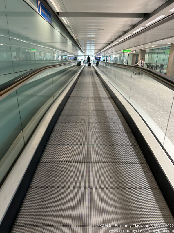 a person standing on a moving walkway