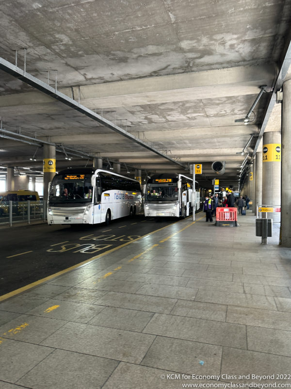 a group of buses parked in a parking garage