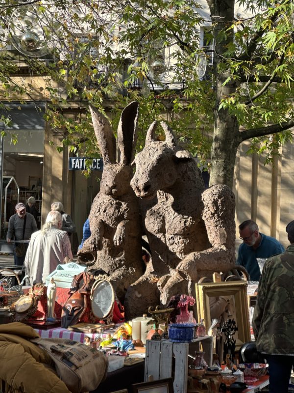 a statue of rabbits and other objects on a table