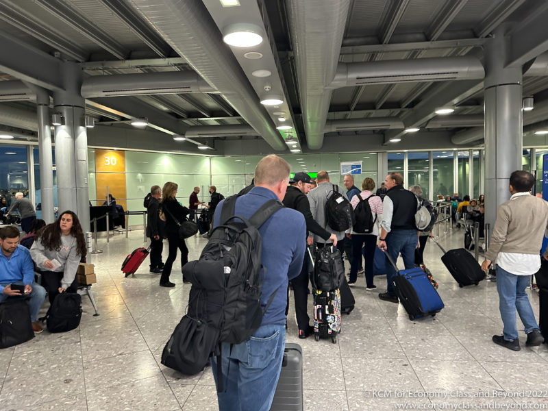 a group of people with luggage in a terminal