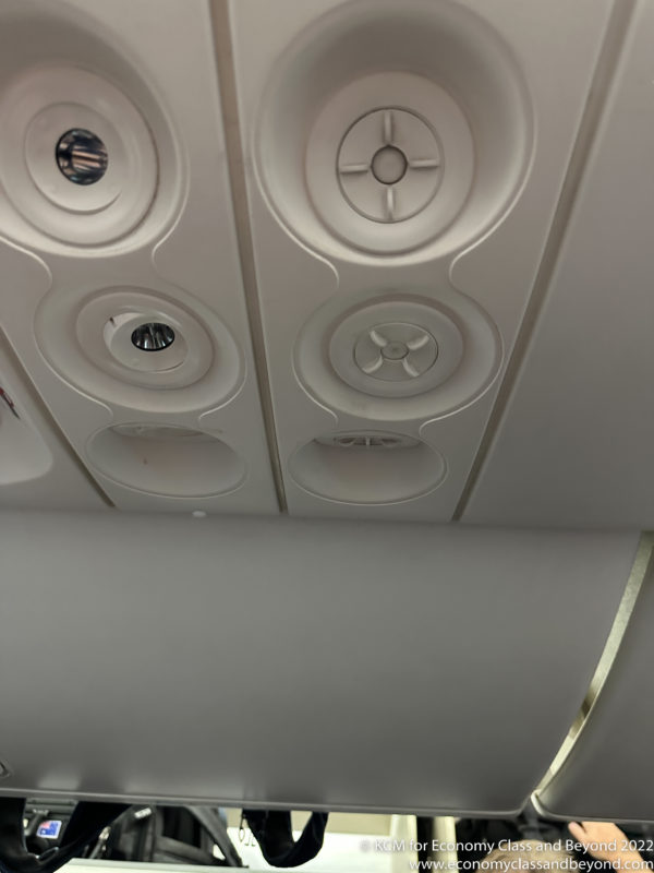 a ceiling with circular holes and a metal strip
