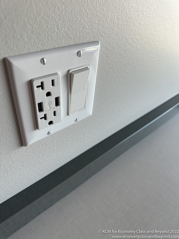 a white outlet with a switch and a light switch