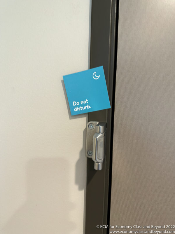 a blue sign on a door handle