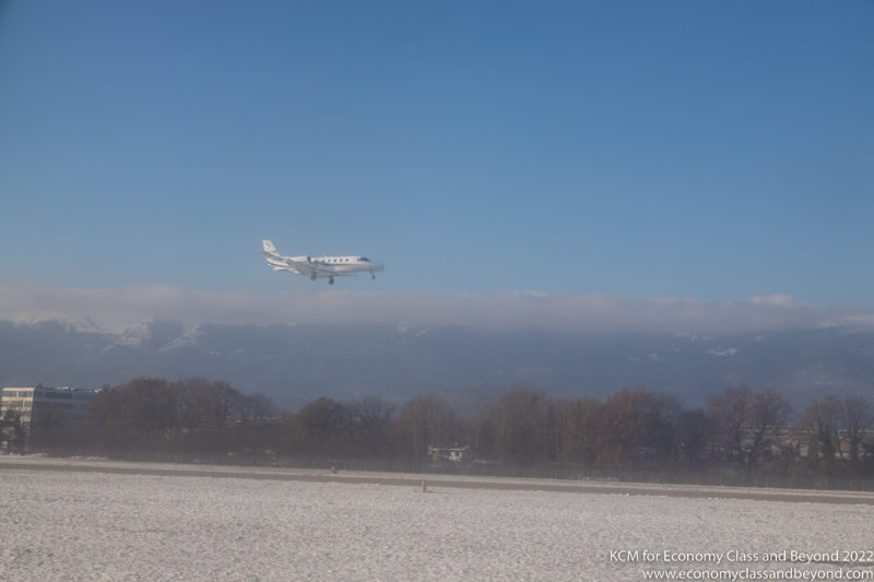 a plane flying over a snowy field