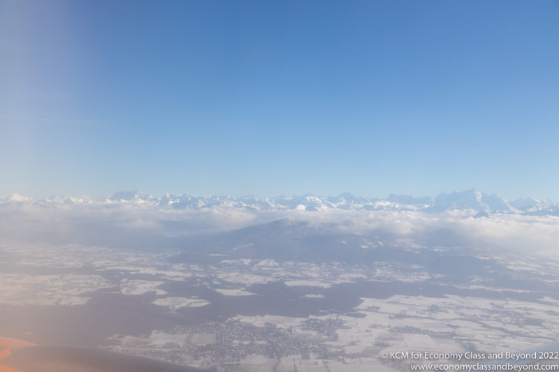 a view of a snowy mountain range from an airplane