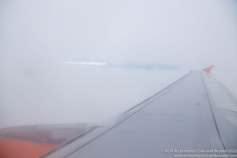 an airplane wing in the clouds