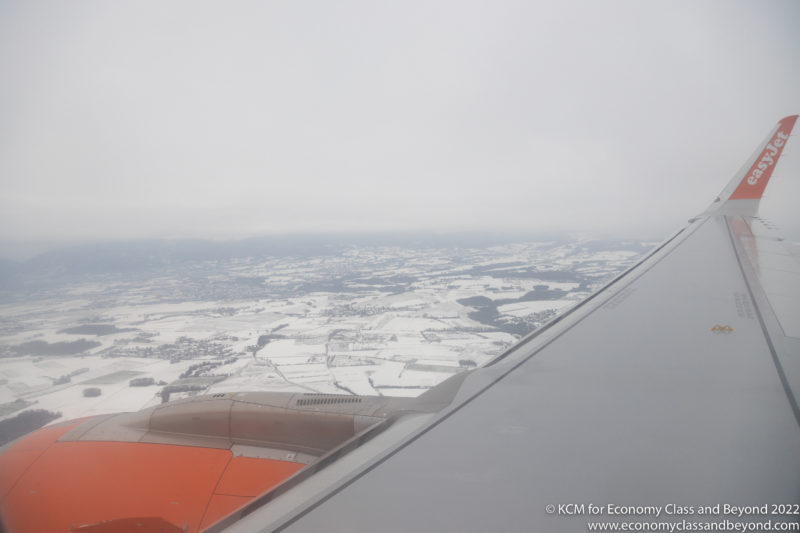 an airplane wing and snow covered ground