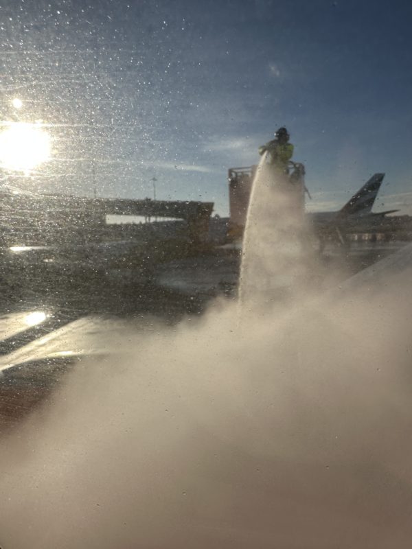 a person spraying water on a plane
