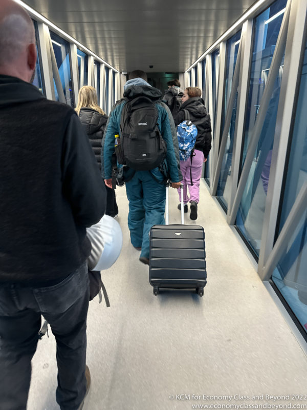 a group of people walking with luggage