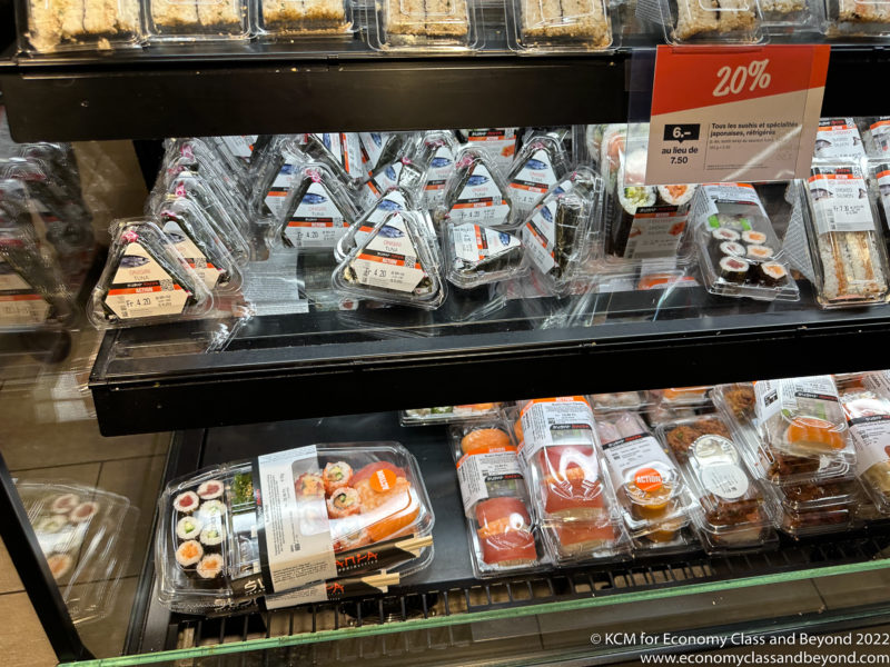 a shelf with food in plastic wrap