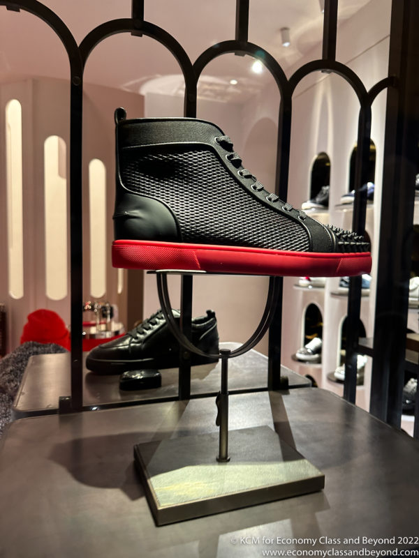 a black and red shoe on a display