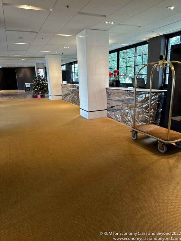 a hotel lobby with a cart and a christmas tree