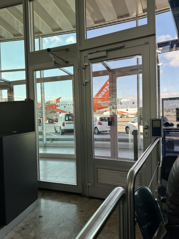 a glass doors with windows and a plane in the background