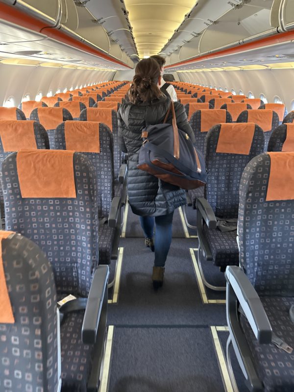 a woman walking in an airplane