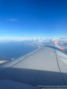 an airplane wing and blue sky