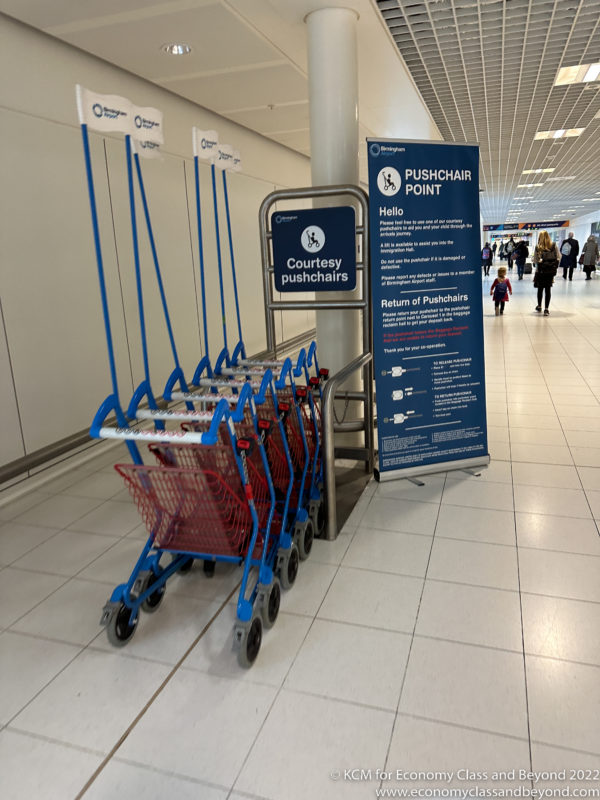 a group of blue and red shopping carts in a hallway