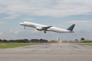 a plane flying over a runway