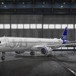 a white airplane in a hangar