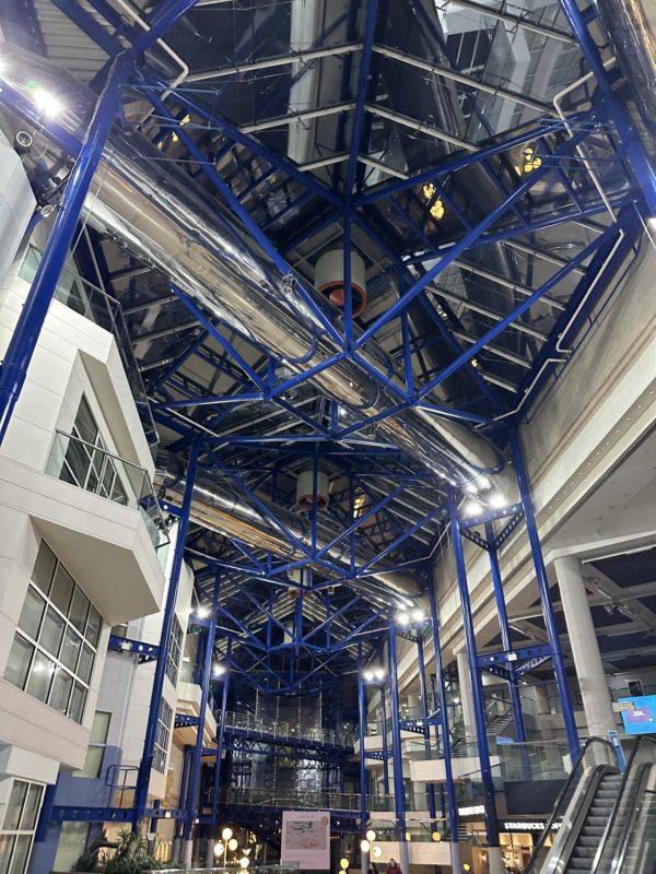 a blue and white metal structure with a glass roof