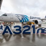 a large white airplane with blue letters on the side