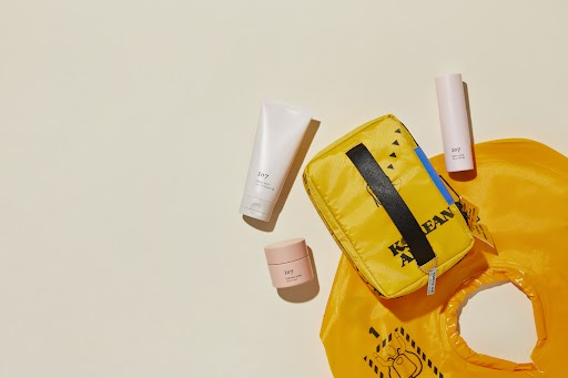 a yellow bag with a tube of cream and other items