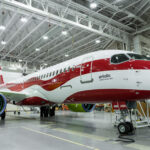 a red and white airplane in a hangar