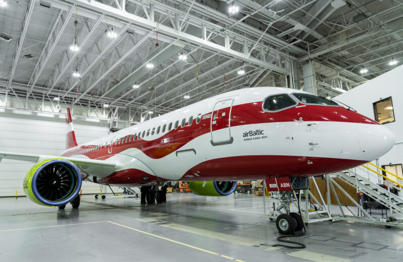 a red and white airplane in a hangar
