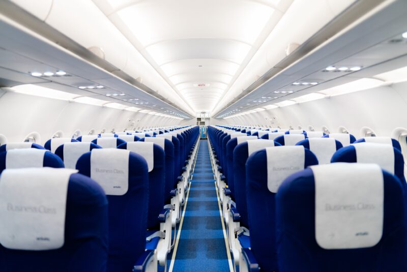 rows of blue seats in an airplane