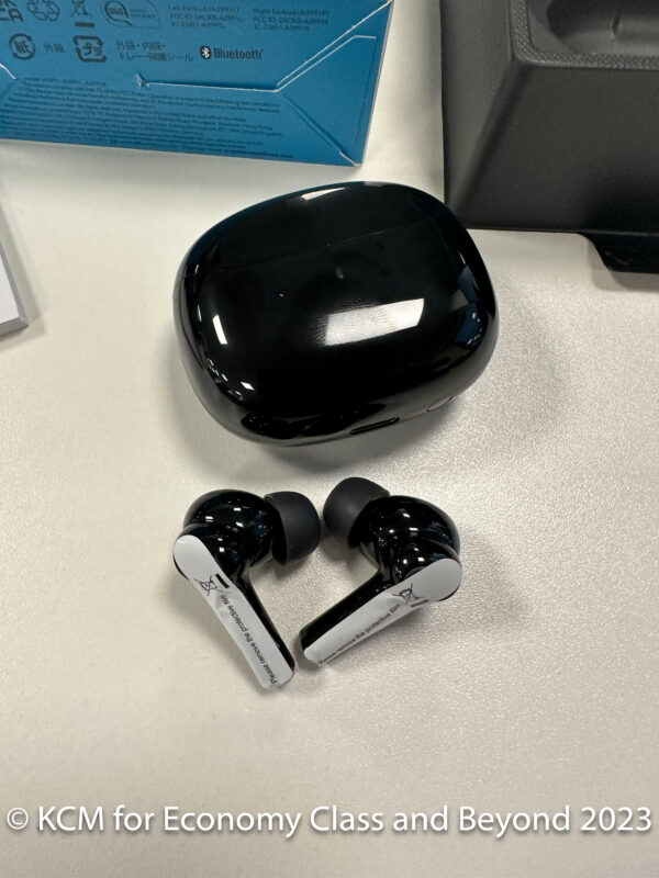 a black earbuds on a white surface