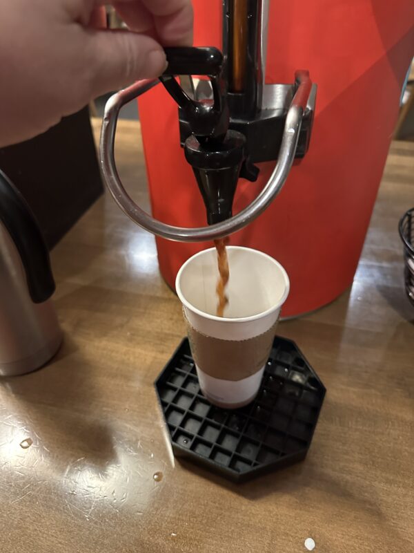 a hand holding a coffee machine