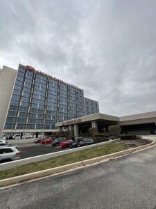 a building with many windows and cars parked in front of it
