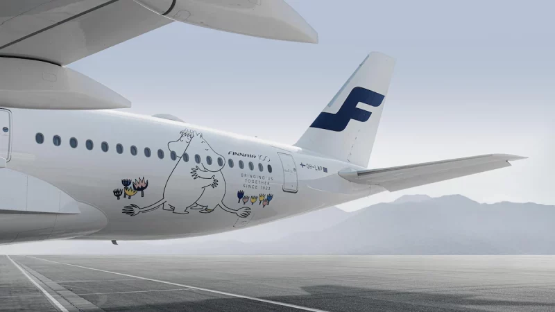 a white airplane with cartoon characters on the side