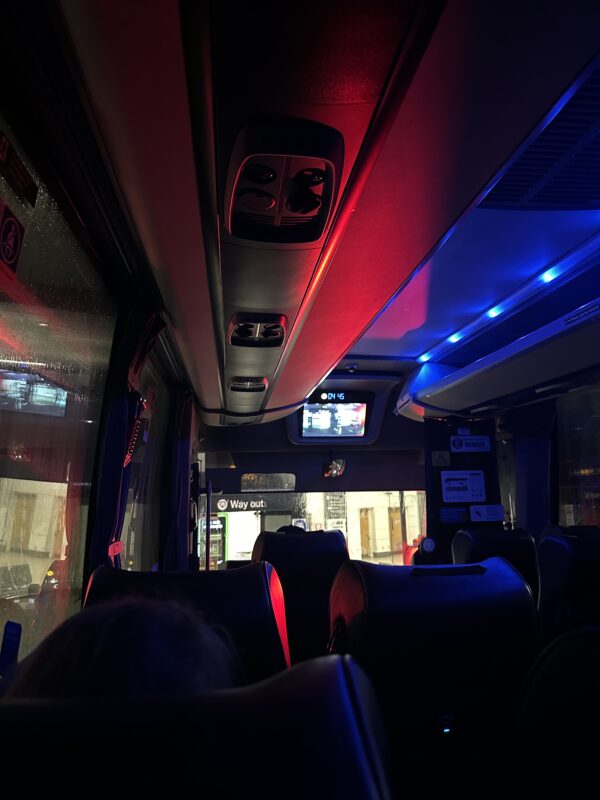 inside a bus with seats and lights