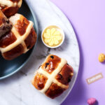 a plate of hot cross buns and butter