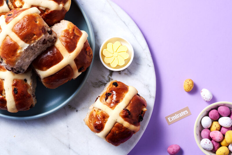a plate of hot cross buns and small egg