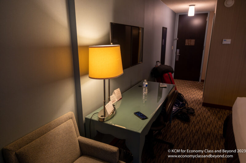 a lamp on a desk in a hotel room