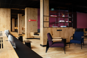 a room with a bench and chairs