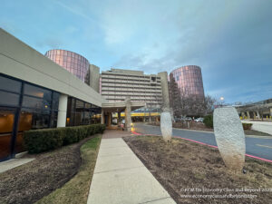 a building with a walkway and a large building