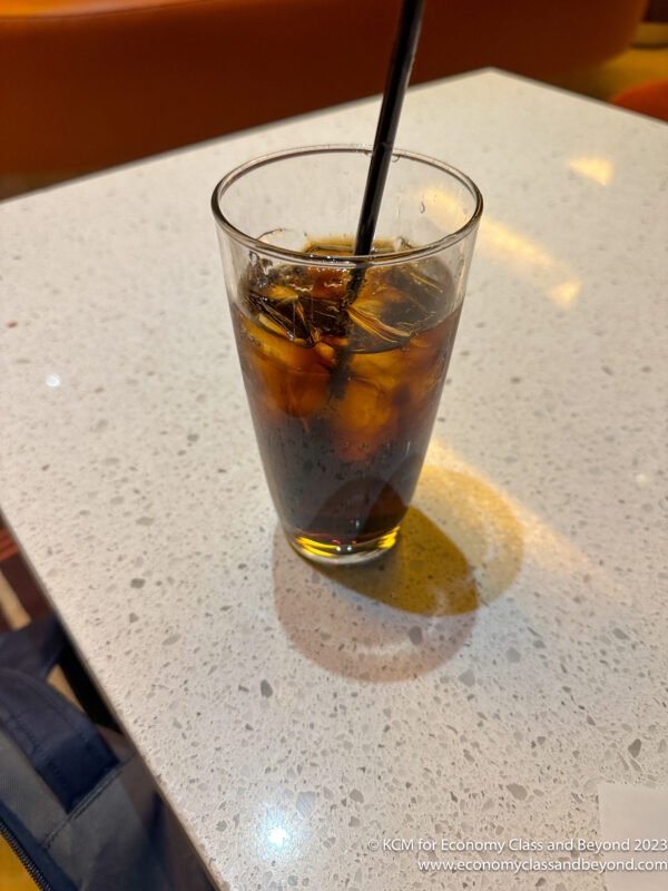 a glass of ice tea with a straw