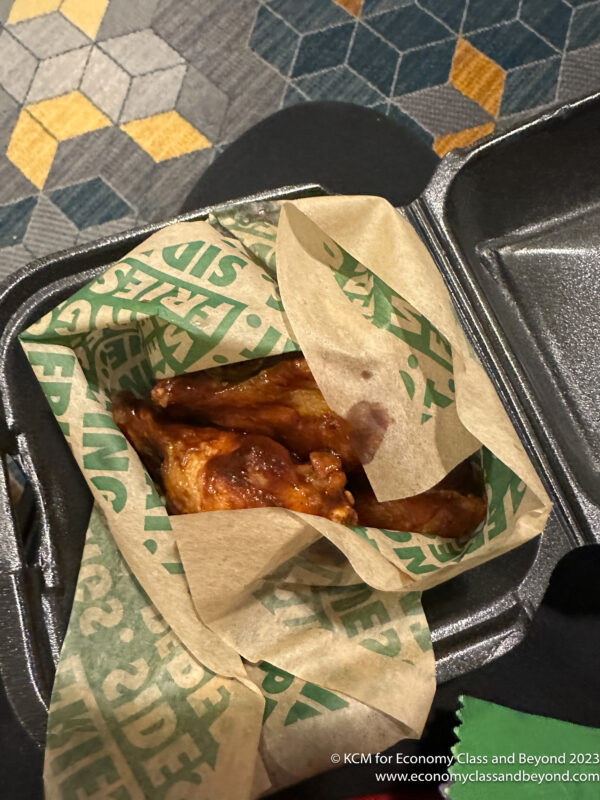 a chicken wings in a black container