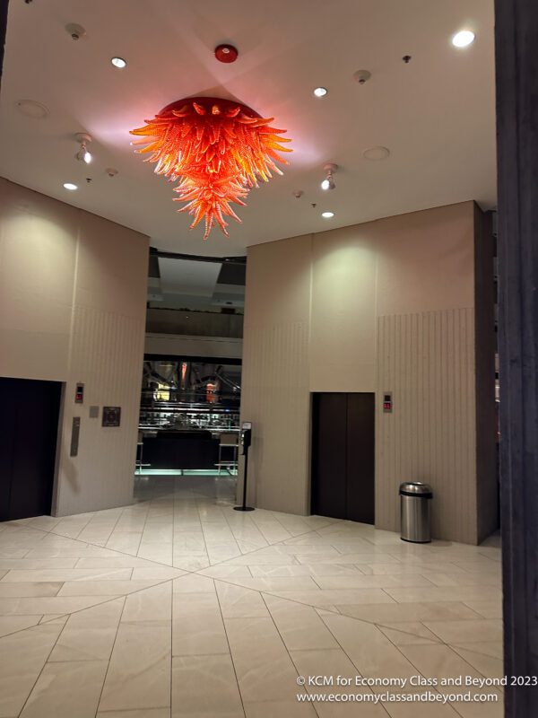 a large orange chandelier in a lobby