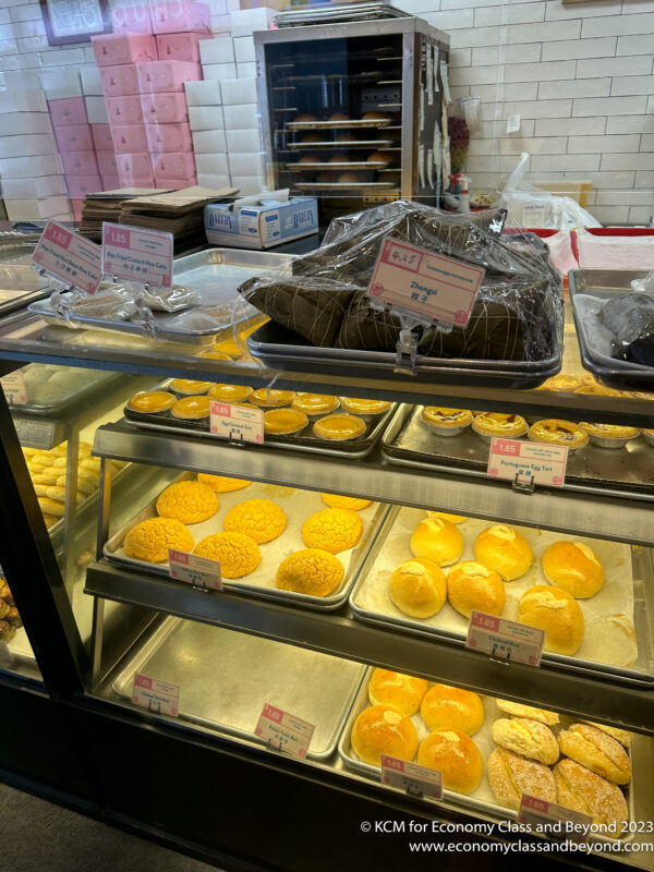 a display case with trays of pastries