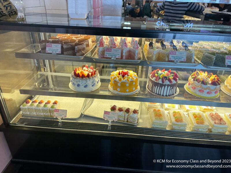 a display case with cakes and desserts
