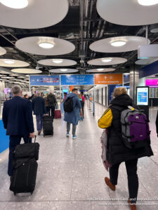 a group of people with luggage in a terminal