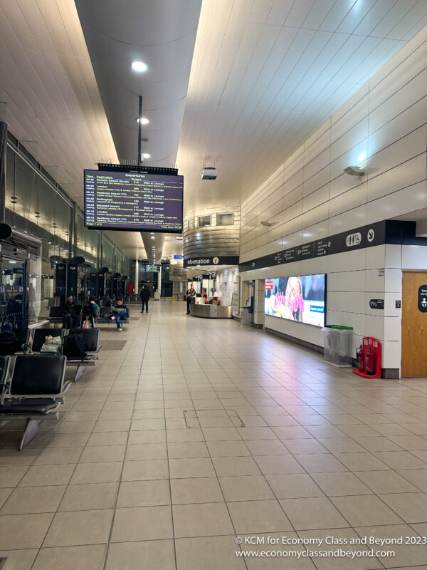 a large airport terminal with a large screen