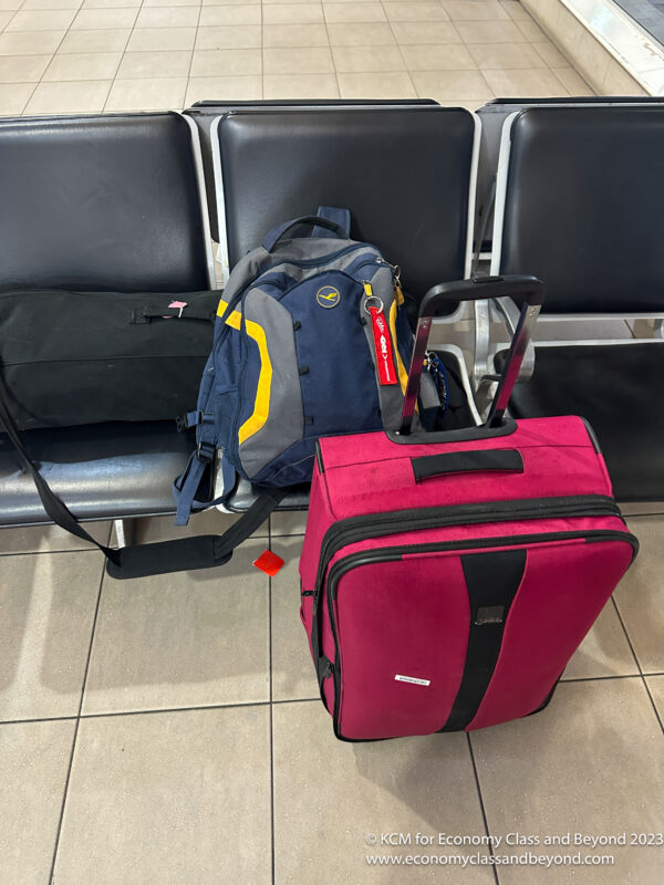 a backpack and luggage on a bench