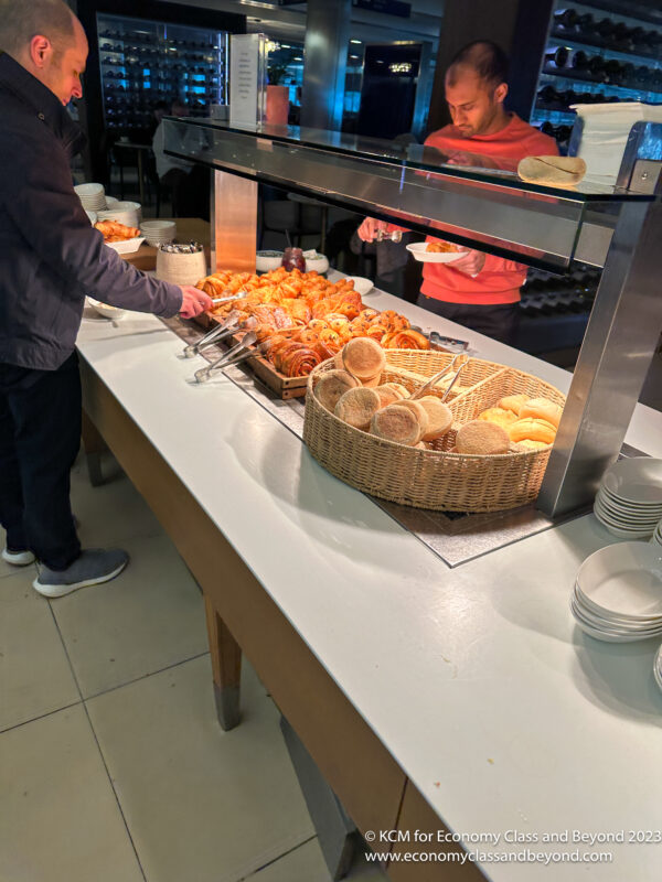 a person serving food at a buffet