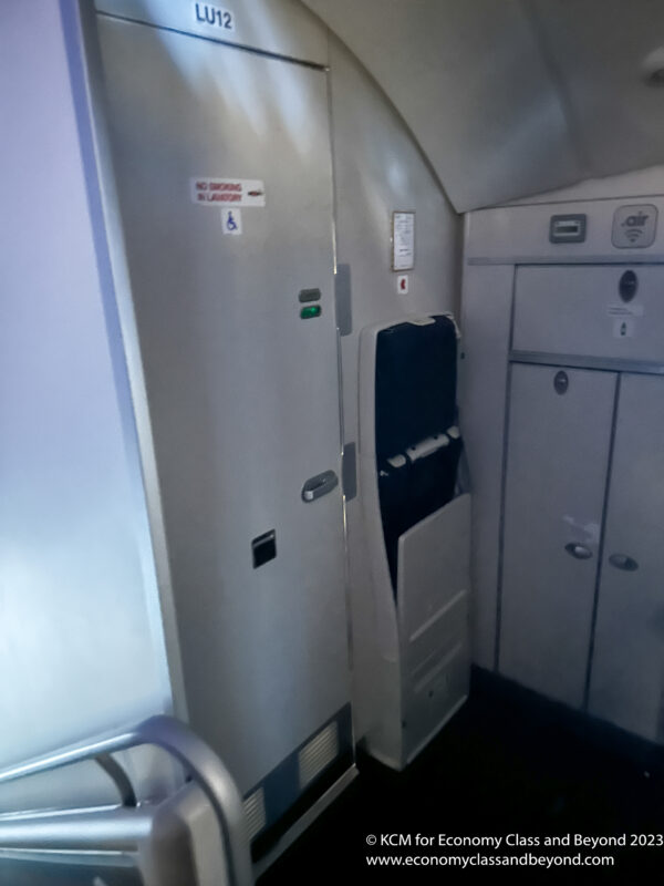 a white door with a black seat and a black seat