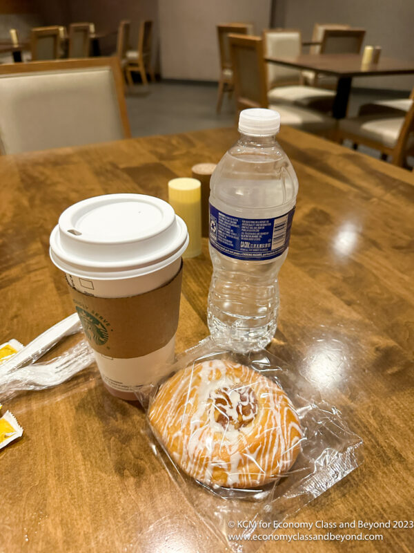 a coffee and a cinnamon roll on a table