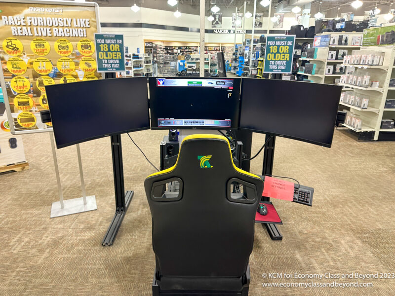 a gaming chair with multiple screens in a store